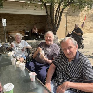 A sunny day spent outdoors with seniors enjoying their snacks and each other's company.