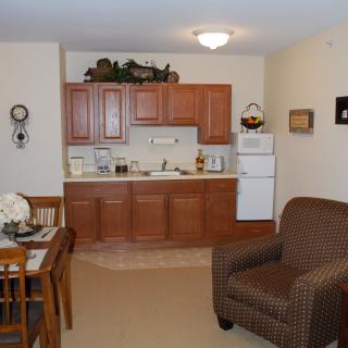 A cozy apartment interior with a kitchen and living area.