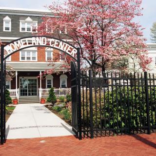 A welcoming entrance to a charming building surrounded by blooming flowers.