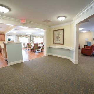 A spacious interior with a carpeted floor, featuring a dining area and comfortable seating.
