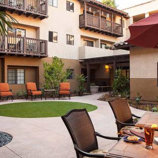 A cozy courtyard with comfortable seating and greenery in a residential building.