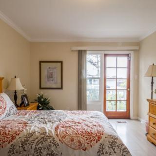 A cozy bedroom with elegant decor and a large window.