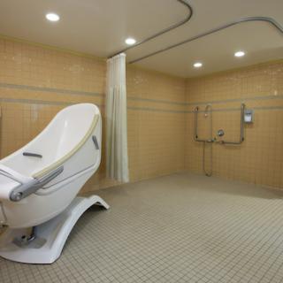 A modern, spacious bathroom featuring a stylish shower area and accessible design elements.