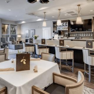 A modern restaurant interior with a bar counter and elegant dining area.