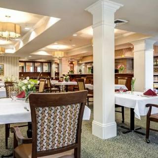 An elegant dining area with neatly arranged tables and chairs.