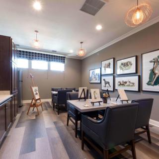 A modern art studio with easels and paintings displayed on the walls.