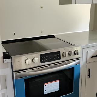 A modern kitchen stove and oven in a new kitchen setup.