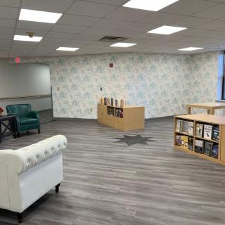 A modern library interior with comfortable seating and organized bookshelves.