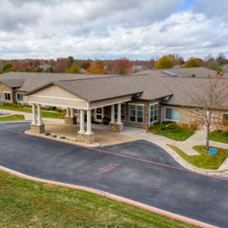 Aerial view of a healthcare facility with a landscaped driveway.