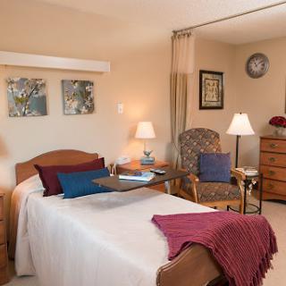A cozy bedroom featuring warm colors and comfortable furnishings.