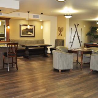 A modern lounge area with comfortable seating and wooden flooring.