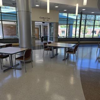 A spacious cafeteria area with modern furniture and ample natural light.