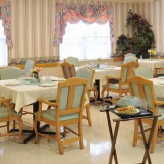 A tidy dining room with neatly arranged tables and chairs, featuring elegant decor.