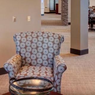 A cozy armchair in a spacious living room setting.