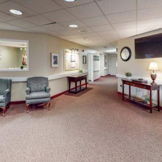 A spacious lobby area with comfortable chairs and a reception desk.