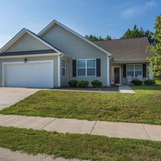 A suburban house with a two-car garage and a well-maintained lawn.