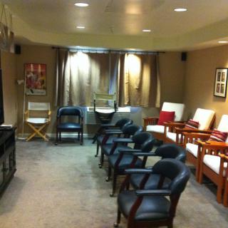 A cozy waiting room with an arrangement of chairs and soft lighting.