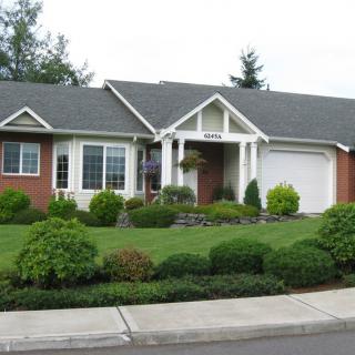 A suburban house with a well-maintained front yard and landscaping.