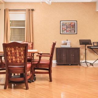 A cozy dining room with wooden furniture and musical instruments.