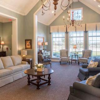 A spacious and elegantly decorated living room with large windows and comfortable seating.