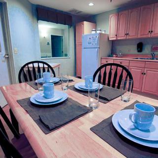 A cozy kitchen and dining area with a set table ready for a meal.
