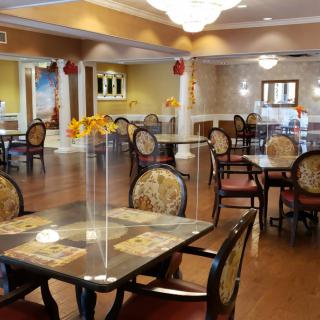 A spacious and elegantly decorated dining area with multiple tables and chairs.