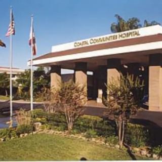 Entrance of a community hospital with flags and landscaping.
