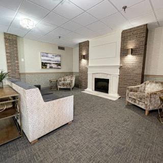 A cozy living room featuring a fireplace and comfortable seating, designed for relaxation.