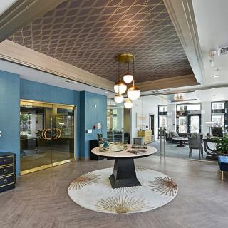 A stylish lobby featuring modern furniture and elegant chandeliers.