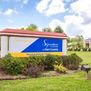 Entrance sign of Signature HealthCARE at Port County, showcasing the facility in a landscaped setting.