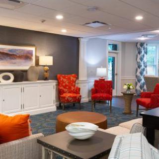 A modern and stylish living room featuring vibrant red chairs and contemporary decor.