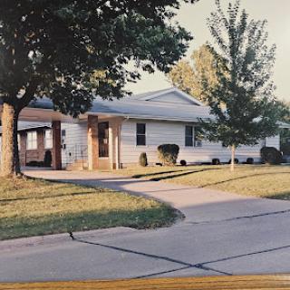 A charming suburban home with a well-maintained yard and driveway.