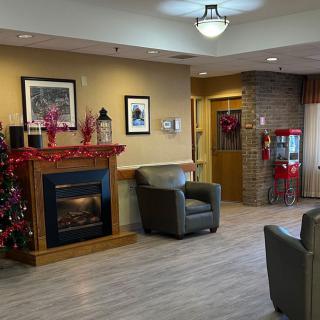 A cozy interior featuring a decorated fireplace and seating area with holiday accents.