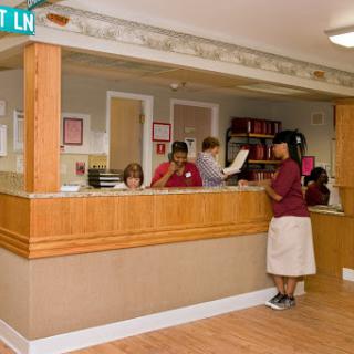 A busy reception area with staff assisting customers.