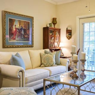 A cozy living room with traditional decor, featuring a comfortable sofa and elegant artwork.