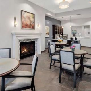 A modern interior space featuring a cozy seating area with a fireplace and elegant decor.