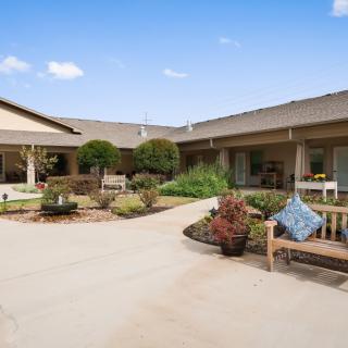 A serene courtyard with seating areas and lush landscaping.