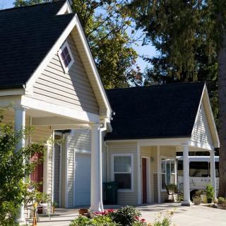 A charming suburban house with a pitched roof and a driveway.