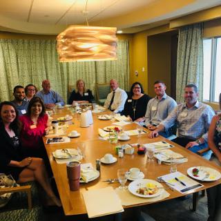 A group of professionals gathered for a business meeting in a conference room.