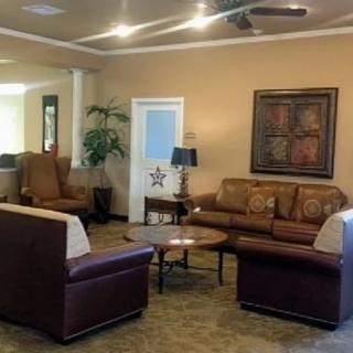 A cozy living room with comfortable sofas, a coffee table, and decorative elements such as artwork and indoor plants.
