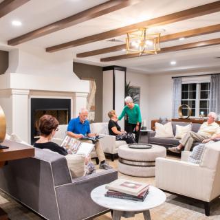 A group of people enjoying a social gathering in a cozy living room.