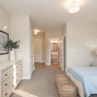 A minimalist bedroom with soft lighting and cozy furnishings.
