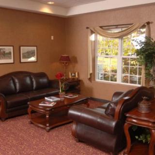 A cozy living room with leather furniture and a warm color scheme.
