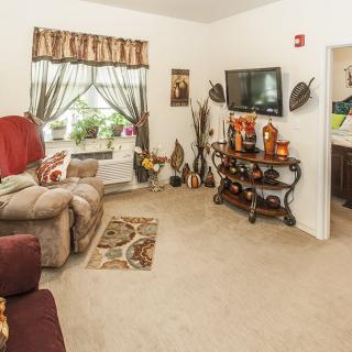 A cozy living room with comfortable seating and decorative elements.