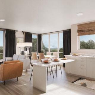 A modern, open-concept living area featuring minimalist furniture and abundant natural light.