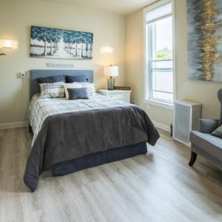 A modern and cozy bedroom with elegant decor and ample natural light.