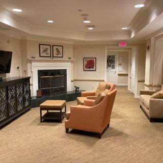 A cozy living room interior featuring comfortable seating, a television, and a fireplace.