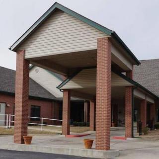 A brick building entrance with a covered walkway.
