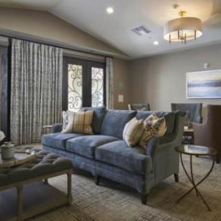 A cozy and modern living room featuring a blue sofa, stylish decor, and a warm ambiance.