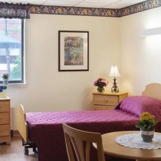 A cozy bedroom with a single bed, nightstand, and decorative elements.